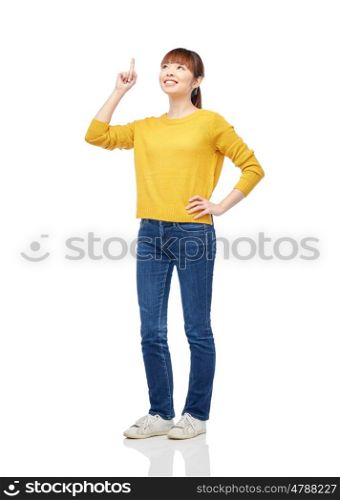 people, ethnicity and idea concept - happy asian young woman pointing finger up over white