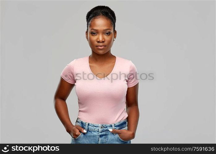 people, ethnicity and portrait concept - african american young woman over grey background. african american woman over grey background