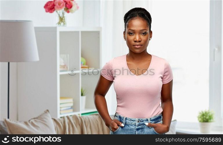 people, ethnicity and portrait concept - african american young woman over home room background. african american woman over home background
