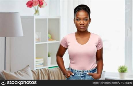 people, ethnicity and portrait concept - african american young woman over home room background. african american woman over home background