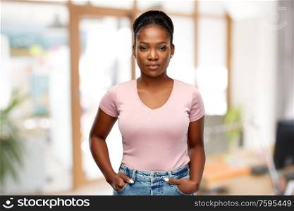 people, ethnicity and portrait concept - african american young woman over office background. african american woman over home background