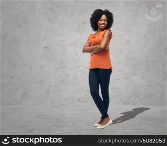 people, ethnicity and portrait concept - happy african american young woman over gray concrete wall background. happy african american young woman over white