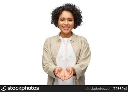 people, ethnicity and portrait concept - happy smiling woman in shirt holding something imaginary in her hands over white background. happy smiling woman holding something in her hands