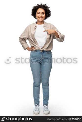 people, ethnicity and portrait concept - happy smiling woman pointing finger to her shirt over white background. happy smiling woman pointing finger to her shirt
