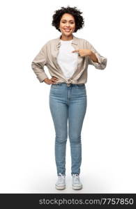 people, ethnicity and portrait concept - happy smiling woman pointing finger to her shirt over white background. happy smiling woman pointing finger to her shirt