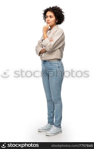 people, ethnicity and portrait concept - thinking woman in shirt and jeans with crossed arms over white background. thinking woman in shirt and jeans