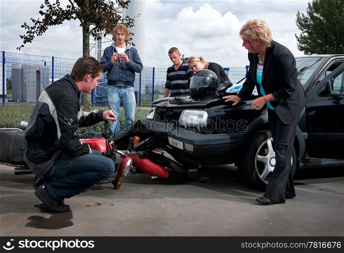 People examining the exterior damage to their vehicles after a car crash
