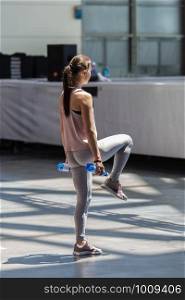 People Exercising with Plastic Water Bottle in Class at Gym with Music and Teacher on Stage.