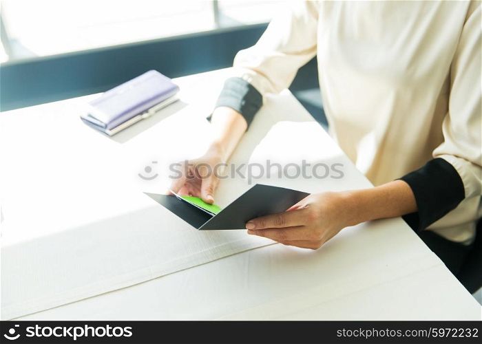 people, expenses, payment and lifestyle concept - close up of woman hands holding restaurant bill
