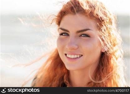 people, facial expression and emotion concept - close up of happy young redhead woman face