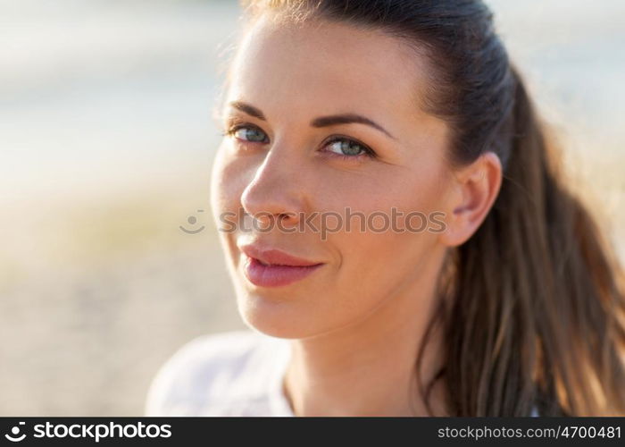 people, facial expression and emotion concept - close up of happy young woman face