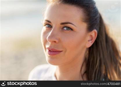 people, facial expression and emotion concept - close up of happy young woman face