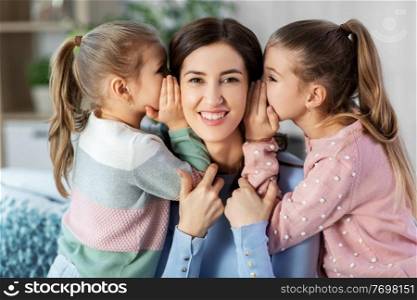 people, family and concept - happy mother and two daughters gossiping at home. happy mother and daughters gossiping at home