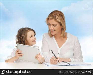 people, family, home education, children and technology concept - happy mother and daughter with tablet pc and notebook over blue sky background