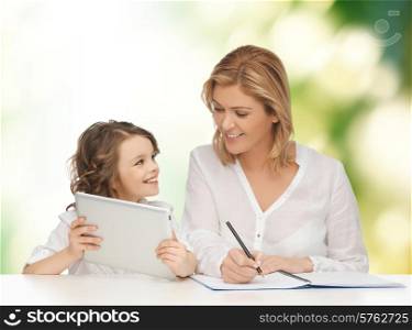 people, family, home education, children and technology concept - happy mother and daughter with tablet pc and notebook over green background