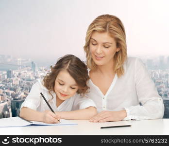 people, family, school, home education and parenting concept -happy mother and daughter doing homework and writing in notebook over city background