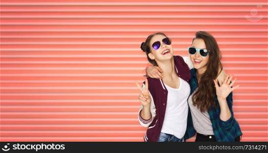people, fashion and summer concept - happy smiling pretty teenage girls or friends in sunglasses showing peace hand sign over striped living coral background. happy teenage girls in sunglasses showing peace