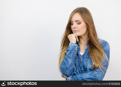 People fashion jeans concept. Attractive young lady wearing denim jacket. Pensively girl with long hair has nice outfit.. Pensively girl with blue shirt.