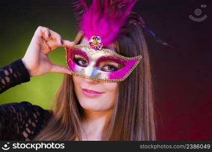 People, fashion, party concept. Sensual woman with carnival mask. Attractive young lady with long brown hair preaparing for celebration.. Sensual woman with carnival mask.