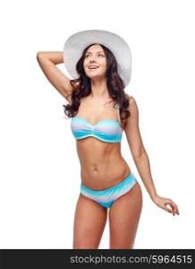 people, fashion, summer and beach concept - happy young woman in bikini swimsuit and sun hat