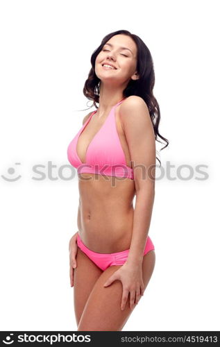 people, fashion, swimwear, summer and beach concept - happy young woman in pink bikini swimsuit