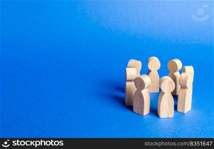 People figurines stand in a circle. discussion, cooperation. Meeting at work, negotiating a plan of action. teamwork. Society and community. Employees briefing. Organization of work and processes