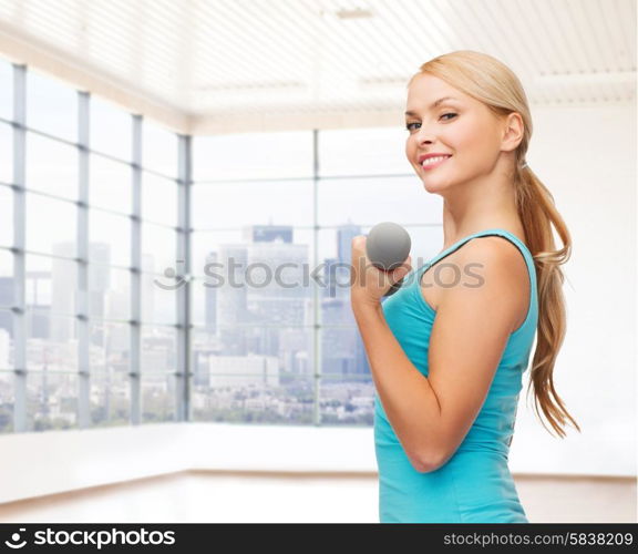 people, fitness and sport concept - close up of happy young woman flexing her biceps over gym or home background