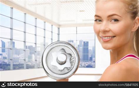people, fitness and sport concept - close up of happy young woman flexing her biceps over gym or home background