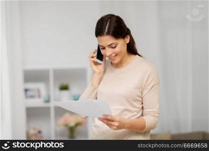 people, freelance and education concept - happy smiling woman with papers on smartphone calling at home. woman with papers calling on smartphone at home. woman with papers calling on smartphone at home