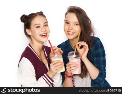 people, friends, teens and friendship concept - happy smiling pretty teenage girls drinking milk shakes and with straw