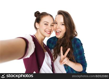 people, friends, teens and friendship concept - happy smiling pretty teenage girls taking selfie and showing peace sign