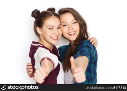 people, friends, teens and friendship concept - happy smiling pretty teenage girls hugging and showing thumbs up