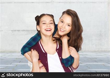 people, friends, teens and friendship concept - happy smiling pretty teenage girls hugging over gray urban street background