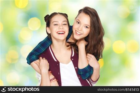 people, friends, teens and friendship concept - happy smiling pretty teenage girls hugging over green summer holidays lights background