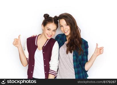 people, friends, teens and friendship concept - happy smiling pretty teenage girls hugging and showing thumbs up