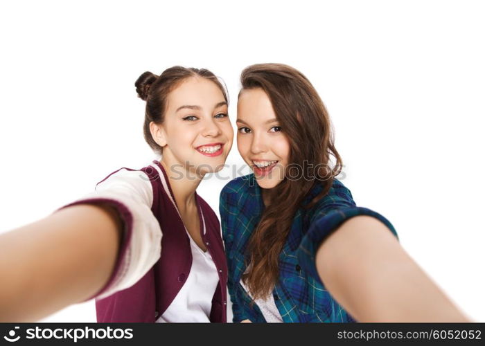 people, friends, teens and friendship concept - happy smiling pretty teenage girls taking selfie