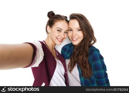 people, friends, teens and friendship concept - happy smiling pretty teenage girls taking selfie