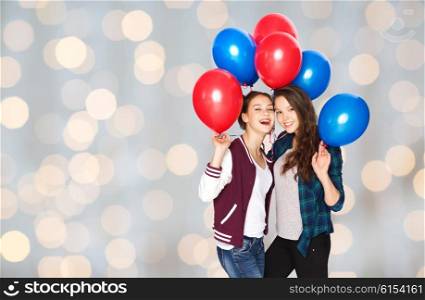 people, friends, teens, holidays and party concept - happy smiling pretty teenage girls with helium balloons over lights background