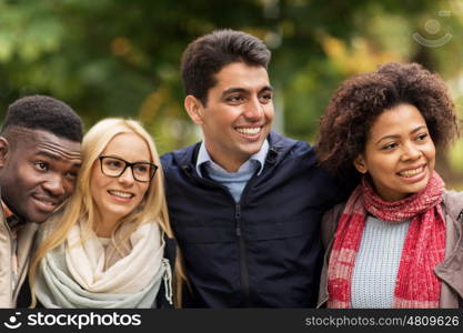 people, friendship and international concept - group of happy friends outdoors