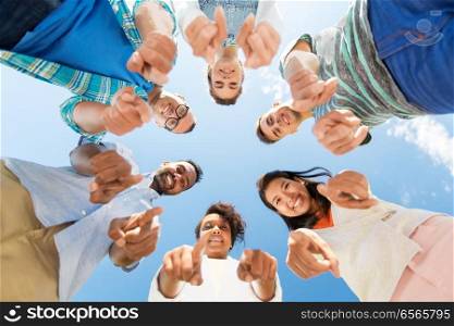 people, friendship and international concept - group of happy smiling friends outdoors standing in circle and pointing at you. happy friends pointing at you standing in circle