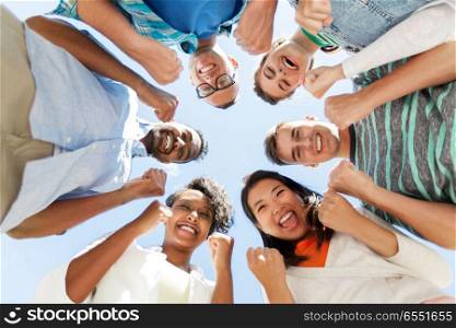 people, friendship and international concept - group of happy smiling friends outdoors standing in circle. happy smiling friends outdoors standing in circle. happy smiling friends outdoors standing in circle