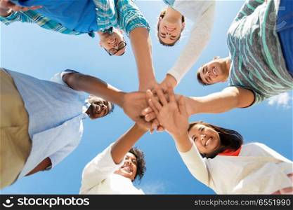 people, friendship and international concept - group of happy smiling friends outdoors standing in circle. happy smiling friends outdoors standing in circle. happy smiling friends outdoors standing in circle