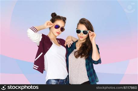 people, friendship, fashion, summer and teens concept - happy smiling pretty teenage girls in sunglasses over pink violet background