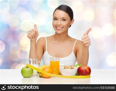 people, gesture and diet concept- happy asian woman with healthy food showing thumbs up over blue lights background