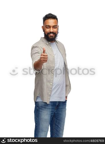 people, gesture and ethnicity concept - happy smiling indian man showing thumbs up over white