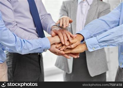 people, gesture and teamwork concept - close up of business team stacking hands. close up of business team stacking hands