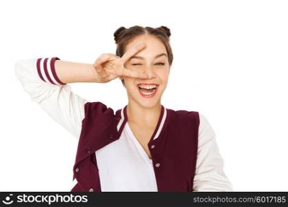 people, gesture and teens concept - happy smiling pretty teenage girl showing peace sign and winking