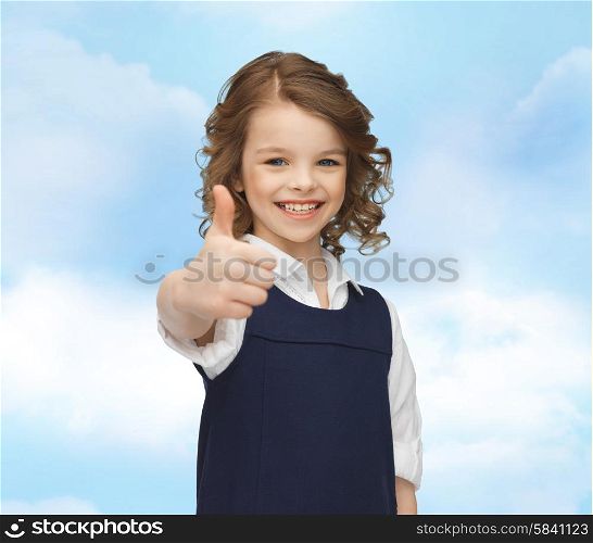 people, gesture, children, summer vacation and happiness concept happy little school girl showing thumbs up blue sky background