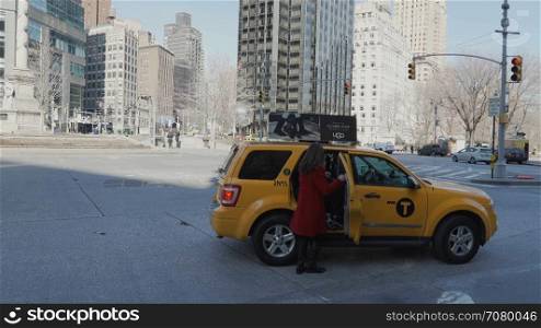 People get into a taxi in New York City