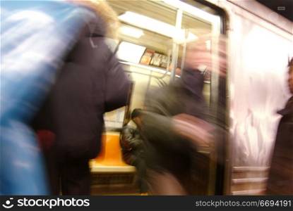 People Getting On and Off a Subway